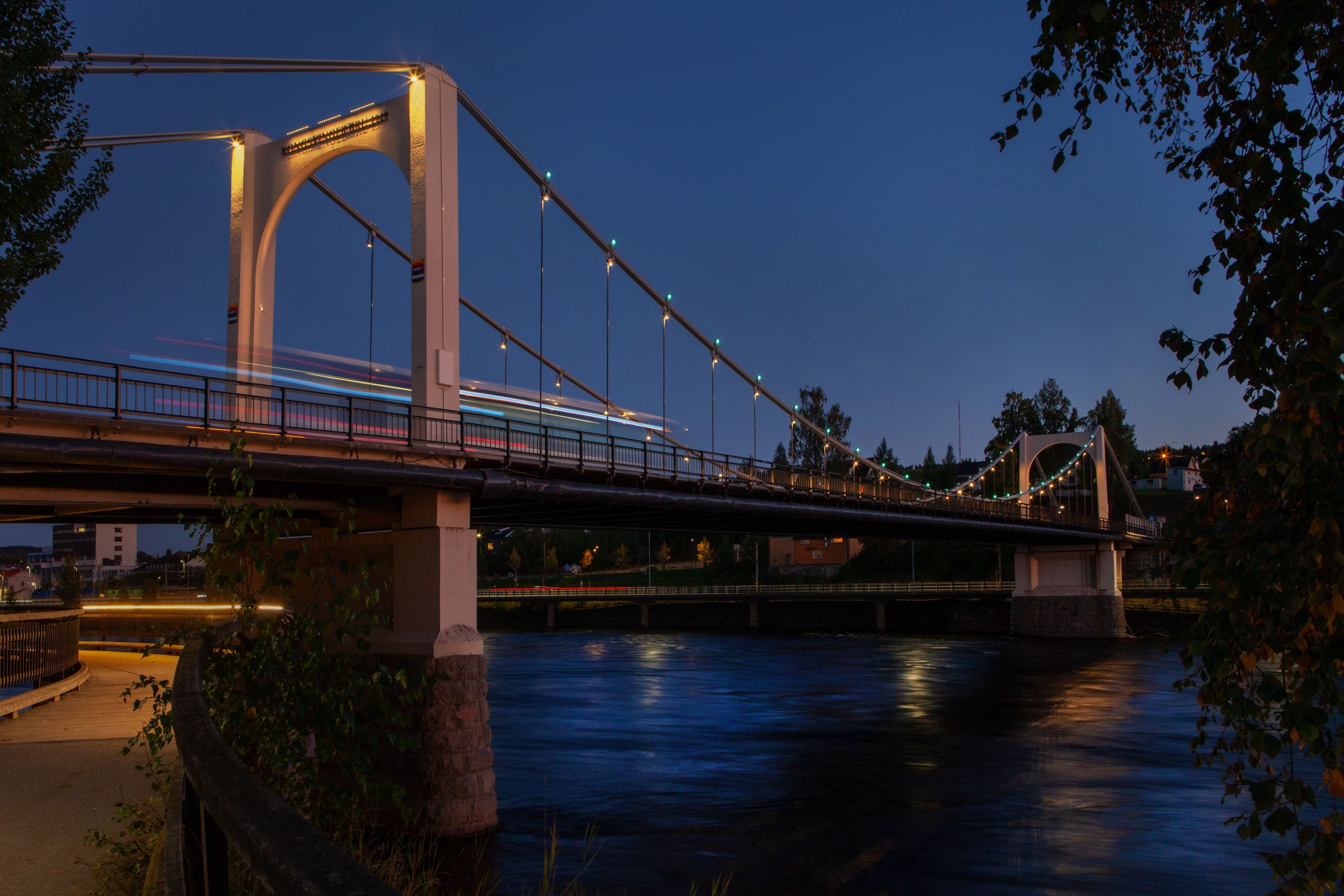 a view of the kongsvinger bridge during blue hour with the new lighting on the pillars and color changing dots on the main cable structure