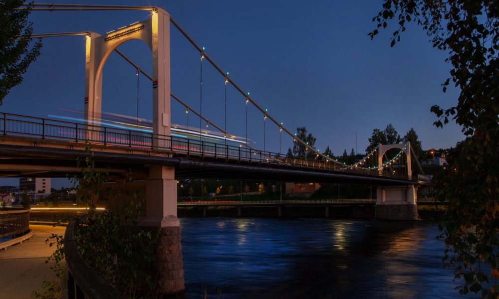 a view of the kongsvinger bridge during blue hour with the new lighting on the pillars and color changing dots on the main cable structure